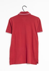 Polo rouge en coton, doté d'un col à rayures blanches, de manches courtes et d'ouvertures latérales à l'ourlet pour faciliter les mouvements.