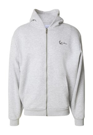 Pilkas užtrauktuku užsegamas džemperis, pagamintas iš švelnios medžiagos, turintis priekinę kišenę ir mažą siuvinėtą logotipą kairiajame krūtinės šone. Reguliuojama raištelių kapota.