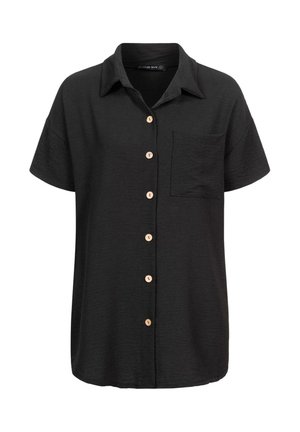 Chemise noire à manches courtes avec un devant boutonné, boutons en bois, et une poche poitrine. Fabriquée dans un tissu texturé.