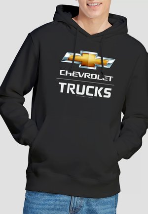 Black hoodie with a front graphic featuring a yellow and silver Chevrolet logo above the word "CHEVROLET" and "TRUCKS" in bold white text.