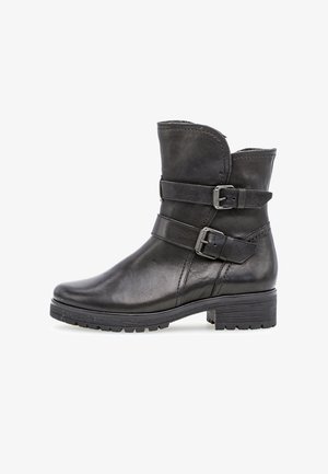 Schwarzer Leder-Stiefeletten mit zwei verstellbaren Riemenschnallen, einer abgerundeten Spitze und einer strukturierten Gummisohle für besseren Halt. Verfügt über einen leicht geschwungenen oberen Rand.