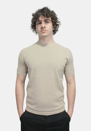 T-shirt beige a maniche corte con scollatura tonda, realizzato in morbido cotone, caratterizzato da un design aderente e privo di motivi o accenti visibili.
