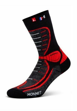 Chaussette de sport noire et rouge avec des accents gris, portant le nom de la marque "Monnet" et l'indicateur de taille "L M" sur le bord supérieur.