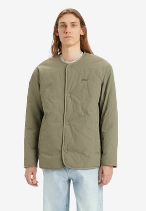 Grüne gesteppte Jacke mit rundem Halsausschnitt, Druckknöpfen und dezentem LEVI'S-Logo. Passt gut zu hellblauer Jeans für einen lässigen Look.