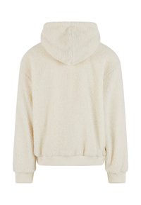 Felpa con cappuccio di colore crema, realizzata in pile con una finitura morbida e tessurizzata. Presenta un cappuccio e polsini a costine, con una vestibilità rilassata e una lunghezza cropped.
