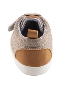 Tan textile sneaker with a soft fabric upper, a brown suede heel accent, and a white rubber sole. Features a fold-down collar and a loop tab.
