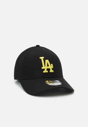 Black cap featuring yellow embroidered "LA" logo on the front, curved visor, and a structured fit with stitching and a tag on the brim.