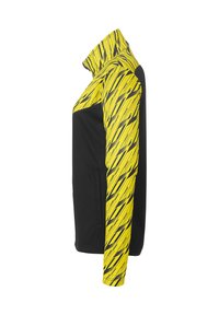 Zwarte jas met een hoge kraag en lange mouwen; geel en zwart diagonale streepjespatroon op één mouw, gladde stoftextuur.