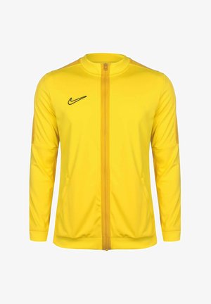 Yellow athletic jacket with long sleeves, zip-front closure, and black logo on the chest. Smooth fabric, fitted design, two side pockets.