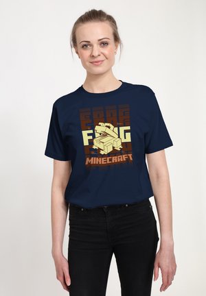 Navy T-shirt with a graphic design featuring light yellow 3D cubes and "MINECRAFT" text in orange and brown, made from cotton fabric.