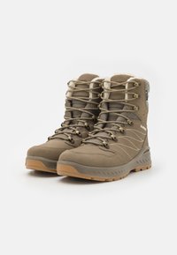 Brown waterproof hiking boots with textile upper, fur lining, reinforced heel, and rubber sole. Features metal eyelets and detailed stitching.