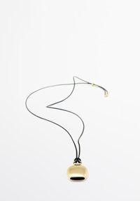 Ciondolo in tonalità oro a forma arrotondata, appeso a una collana con cordino nero. Texture liscia con finitura lucida, presenta un'apertura piccola nella parte inferiore.