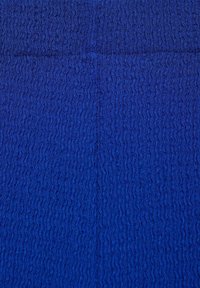 Deep blue material with a textured, wavy pattern. The surface appears soft and slightly reflective, with uniform coloration throughout.