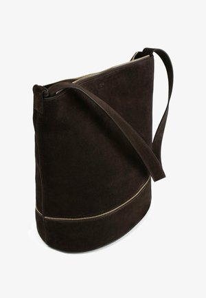 Brown suede shoulder bag with a rounded shape, gold zipper accent, and a long strap, featuring a smooth texture and minimalist design.