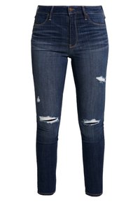 Mörkblå högmidjade skinny jeans i denim, med slitningar på varje knä och en standarddragkedja och knappstängning.