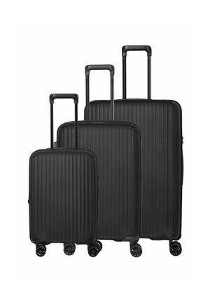 Three black hard-shell suitcases with vertical ridges, telescoping handles extended, and four spinner wheels, shown in small, medium, and large sizes.