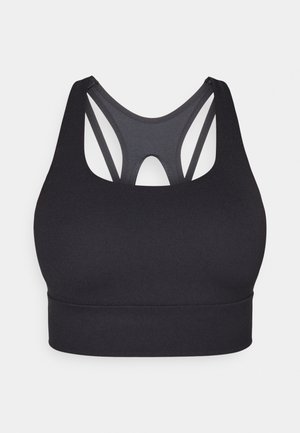 Črni športni modrček z dirkaškim hrbtnim delom, izvrtino in gladkim, raztegljivim materialom. Preprosta, brezšivna izdelava.