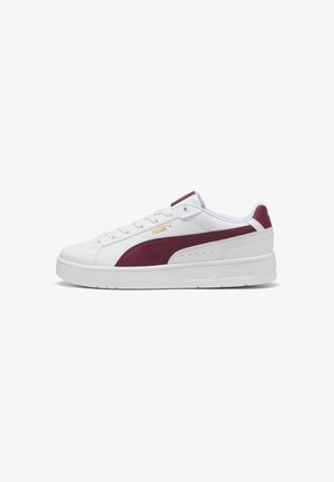 White sneaker with maroon accents, smooth leather upper, round toe, flat sole, and lace-up design. Features a logo near the heel.
