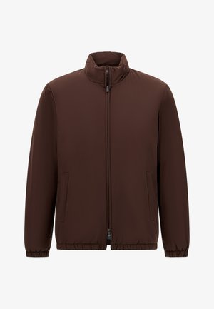 Rudas pūkuotas švarkas su aukštu kaklu, priekine užtrauktuko uždarymo, ir elastinėmis rankovėmis. Turi šonines kišenes ir lygią, matinę tekstūrą.