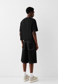 Bershka Farkkushortsit - black