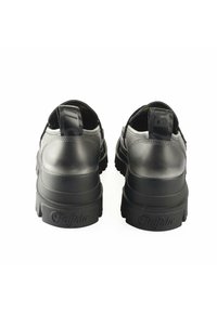 Black leather shoes with a chunky sole, featuring a smooth texture, rounded shape, and a reinforced heel with a pull tab for easy wear.
