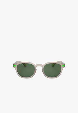 Occhiali da sole con montatura beige, lenti verde scuro e piccoli dettagli verdi su ogni asta, mostrati su uno sfondo bianco.