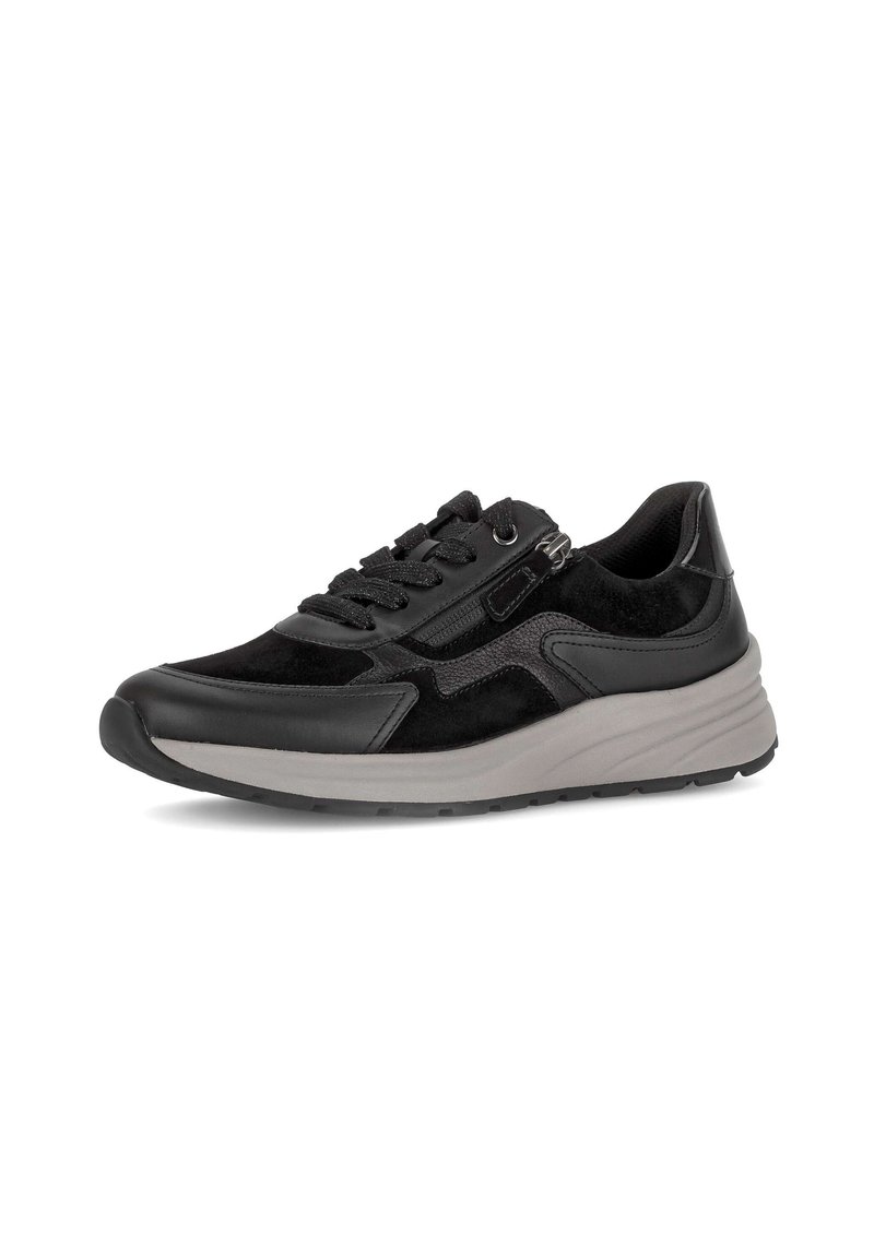 Zwarte sneaker met een bovenwerk van gemengd leer en suède, vetersluiting, zijrits en een dikke lichtgrijze zool, schuin rechts op een witte achtergrond.