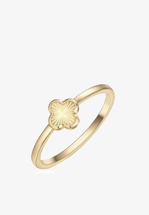 Zlatý prsteň s tenkým pásikom, na ktorom je plochý dizajn vo forme štvorlistovej ďateliny so žiarivými vyrytými líniami v strede.