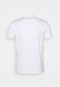 Witte polo shirt met kleine blauwe stippen, korte mouwen, een klassieke kraag en zijslitsen aan de zoom voor extra comfort.