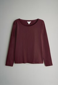 Bordeaux lange mouw shirt met een ronde halslijn. Gemaakt van zachte stof, met een relaxte pasvorm en minimale stikseldetails.