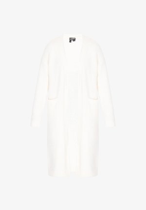 Hosszú, nyitott kardigán puha, bolyhos fehér anyagból. Két elülső zsebe és bordázott mandzsettái vannak. Egyenes szabás, amely a comb közepéig ér.