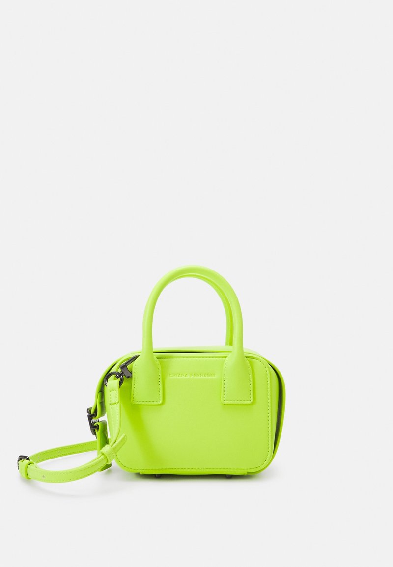 Petit sac à main vert néon lumineux avec doubles anses et bandoulière amovible sur fond blanc.