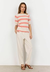 Lightweight knit top with pink and cream stripes, short sleeves, paired with loose cream trousers and brown heeled sandals.