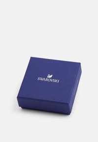 Swarovski Geschenkbox, quadratische Form, strukturierte dunkelblaue Oberfläche, mit weißem Logo oben. Solide Bauweise, kompakte Größe und klares Design.
