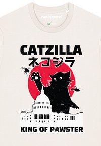 Cremefarbenes T-Shirt mit einem Grafik eines Katers vor einem roten Kreis, dem U.S. Capitol und Hubschraubern; der Text lautet "CATZILLA" und "KING OF PAWSTER."