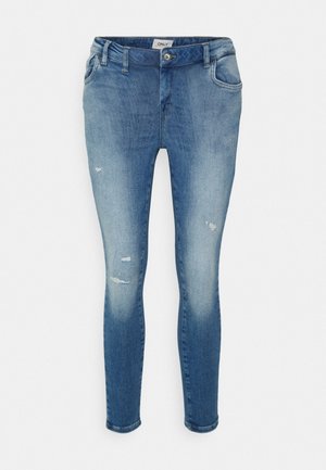 Jean skinny bleu avec légère détérioration aux cuisses et aux genoux, poches avant, fermeture par bouton et étiquette de marque sur la ceinture.