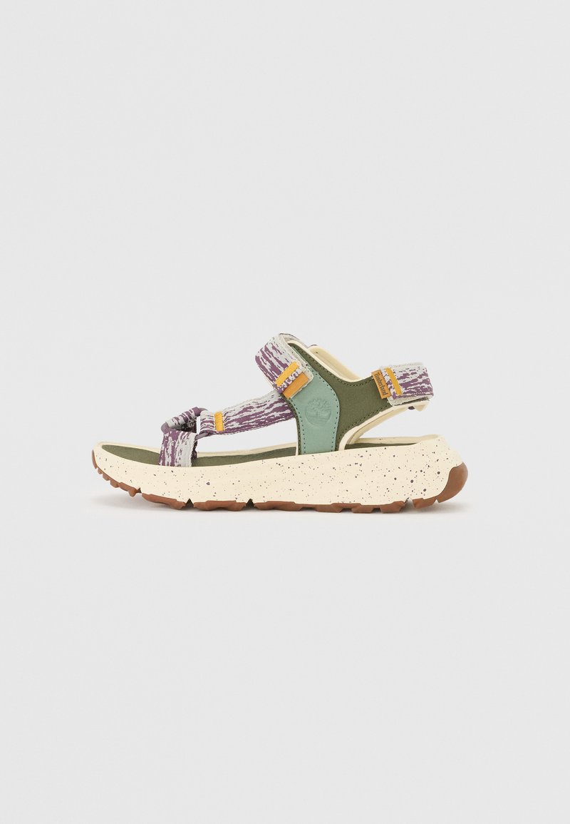 Strappy sandal featuring a purple and white patterned upper, green accents, and a speckled beige sole with a textured finish.