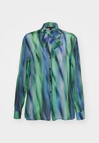 Blusa a maniche lunghe in tessuto trasparente con un motivo ondulato blu e verde. Presenta un collo annodato e bottoni neri sulla parte anteriore.