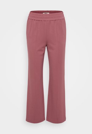 Priliehavé, ľahké nohavice v jemnej ružovej farbe. Majú elastický pás a široké, rovné nohy. Mäkká tkanina bez viditeľných vzorov.