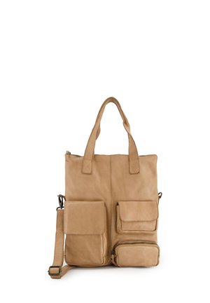 Beige leren boodschappentas met twee handvatten bovenaan, een verstelbare schouderband en drie externe zakken. Kenmerkt zich door een gladde textuur en minimale hardware.