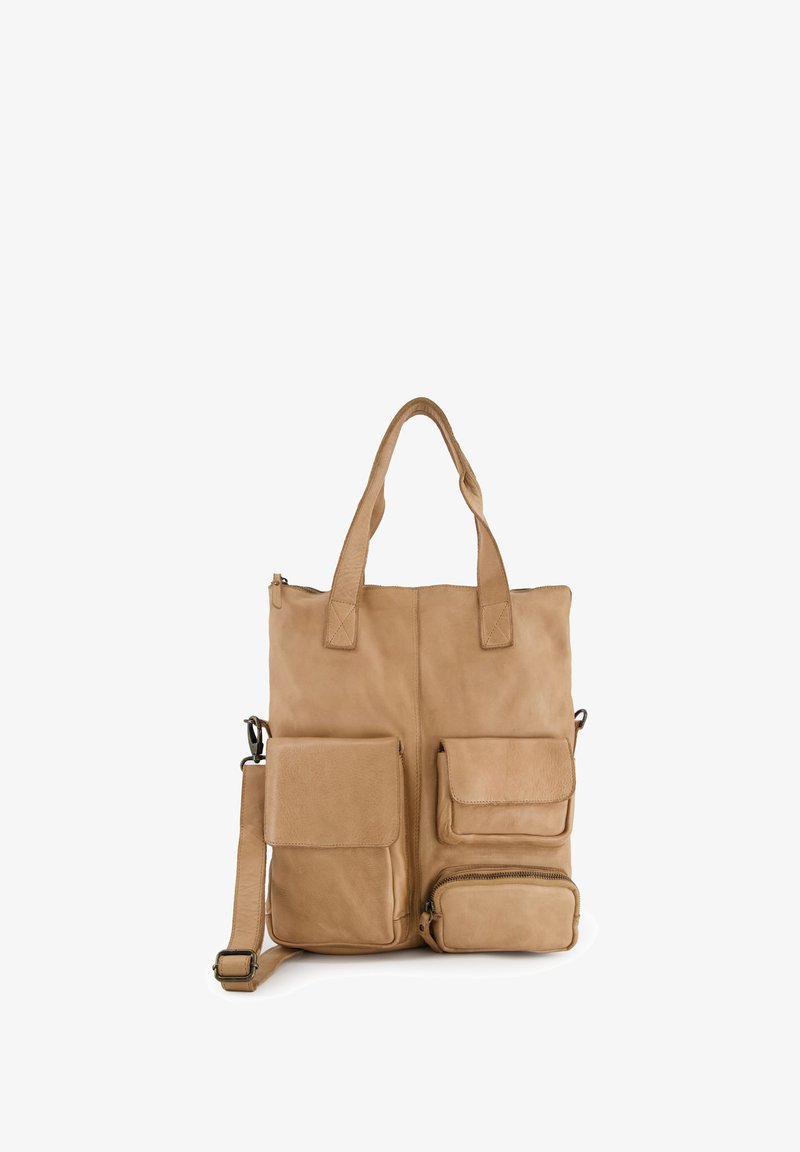 Beige leather tote bag with two top handles, an adjustable shoulder strap, and three external pockets. Features smooth texture and minimal hardware.