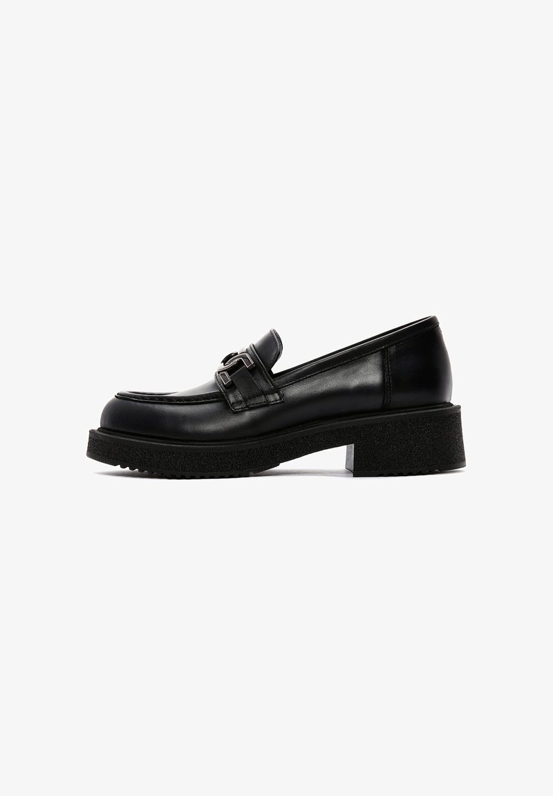 Black leather loafers with a glossy finish, featuring a decorative buckle, a thick textured sole, and a low block heel.