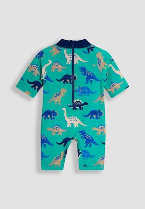 Īsām piedurknēm, teal krāsas bērnu peldkostīms ar dinozauru rakstiem dažādās zilonī un bēšās krāsās, ar rāvējslēdzēju aizmugurē.