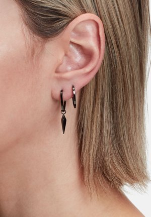 Schwarze Metall-Hoop-Ohrringe mit einem spitzen Akzent, der vom Ring hängt. Glatte Oberfläche mit glänzendem Finish.