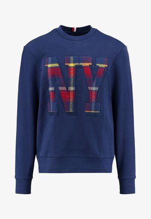 Granatowa bluza z okrągłym dekoltem, ozdobiona dużą aplikacją „NY” z tkaniny w kratę w kolorach czerwonym, żółtym i niebieskim. Wykonana z miękkiej bawełny.