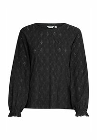 Blouse noire à manches longues avec un motif en dentelle texturée, un col rond et des poignets froncés avec des bords festonnés.