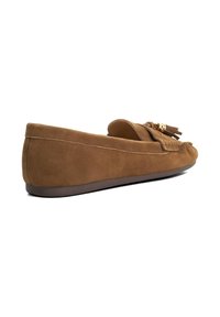 Brown suede loafers with a flat sole, featuring a round toe and decorative tassels on the front. Smooth texture with minimal stitching detail.
