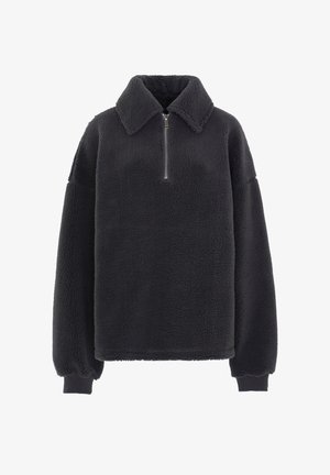 Felpa in pile grigio scuro con colletto con zip, cuciture delle spalle scese e polsini elasticizzati. Texture morbida con una vestibilità casual e rilassata.