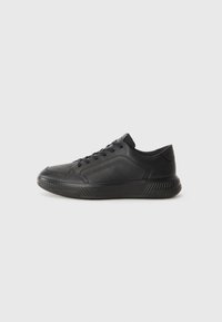Black leather sneakers with a rounded toe, textured upper, lace-up design, and a chunky sole featuring geometric accents.