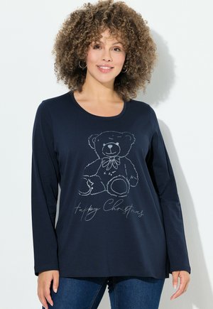 T-shirt à manches longues bleu marine avec un contour argenté d'un ours en peluche portant un nœud, accompagné du texte imprimé "Joyeux Noël" en dessous. Tissu doux, coupe décontractée.